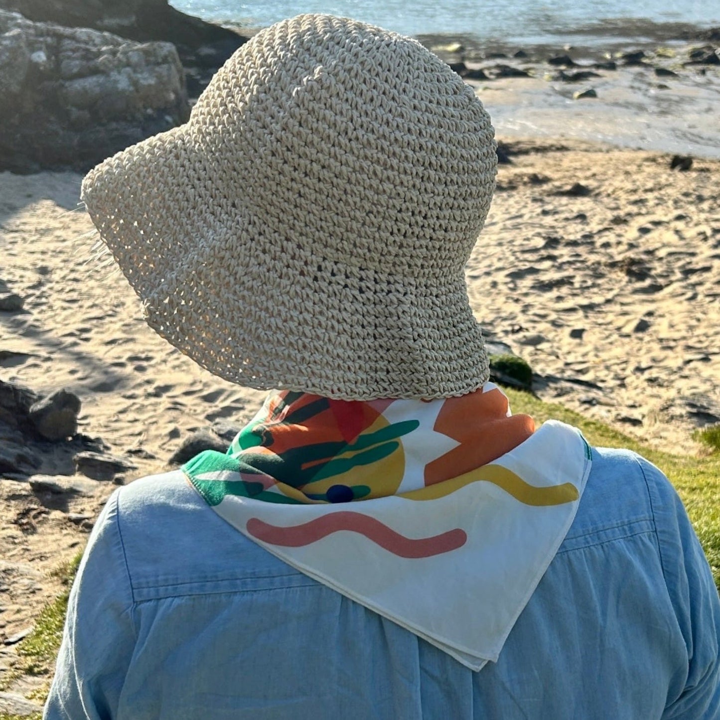 Our scarf for this season has a wave motif as our nod to the sea and a sunset too - a good head scarf or a neckerchief keep the rays off during a rest on the beach.