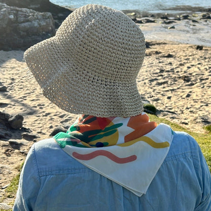 Our scarf for this season has a wave motif as our nod to the sea and a sunset too - a good head scarf or a neckerchief keep the rays off during a rest on the beach.